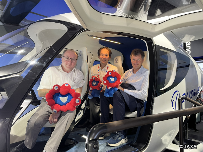 Seated inside the full-scale mock-up of the SkyDrive SD-05 eVTOL aircraft at the Advanced Air Mobility Station, Expo 2025, Osaka, Kansai, Japan.