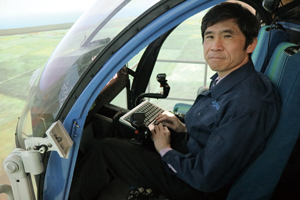 Funabiki adjusting a device in FSCAT-R, a JAXA flight simulator (helicopter)
